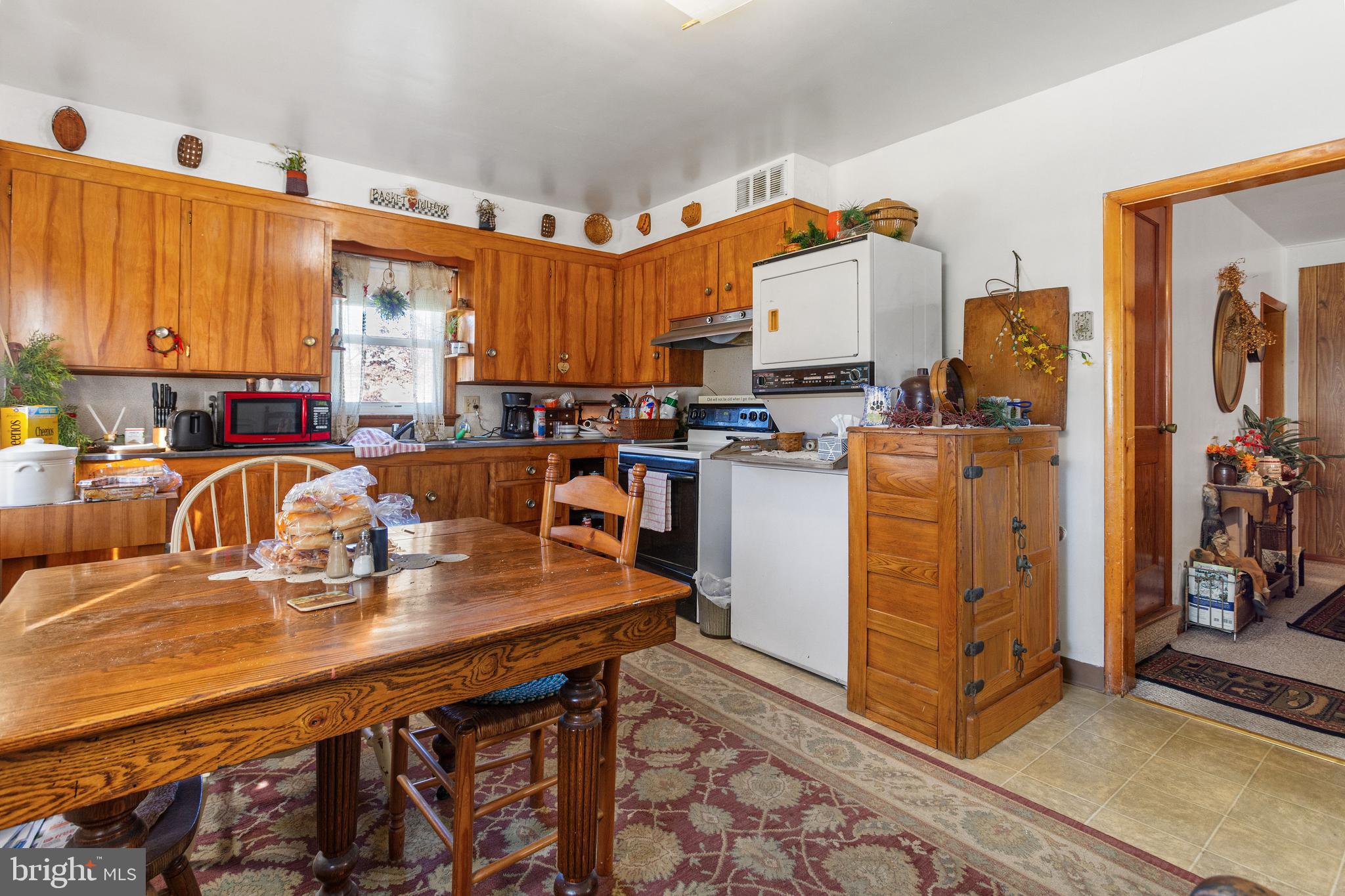 400 Linden Avenue Hanover, PA 17331 - Photo 9 of 43 a kitchen with stainless steel appliances granite countertop a stove top oven a refrigerator a sink dishwasher with a dining table and chairs with wooden floor