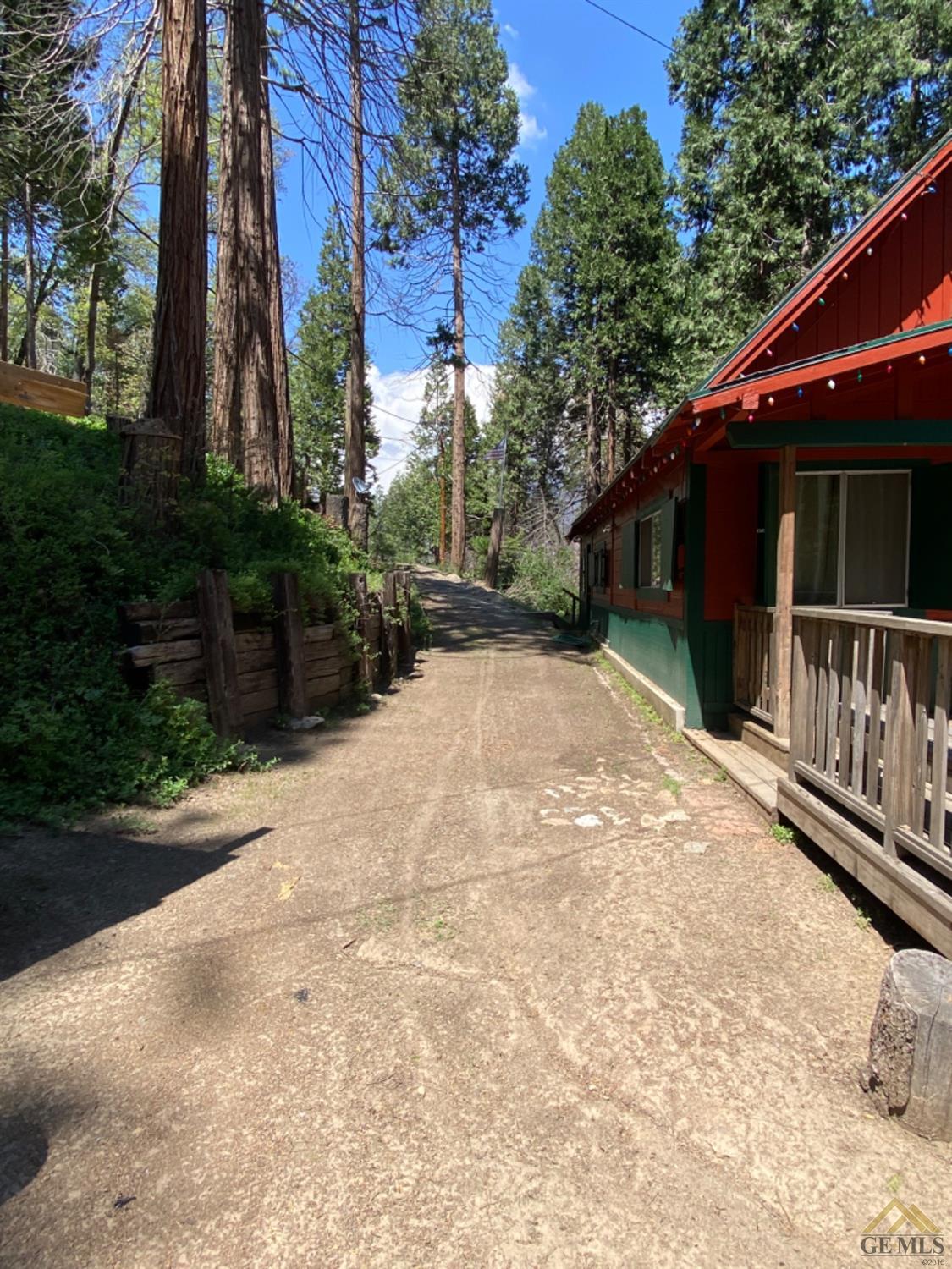 Undisclosed Address Posey, CA 93260 - Photo 19 of 20 a backyard of a house with wooden fence and trees