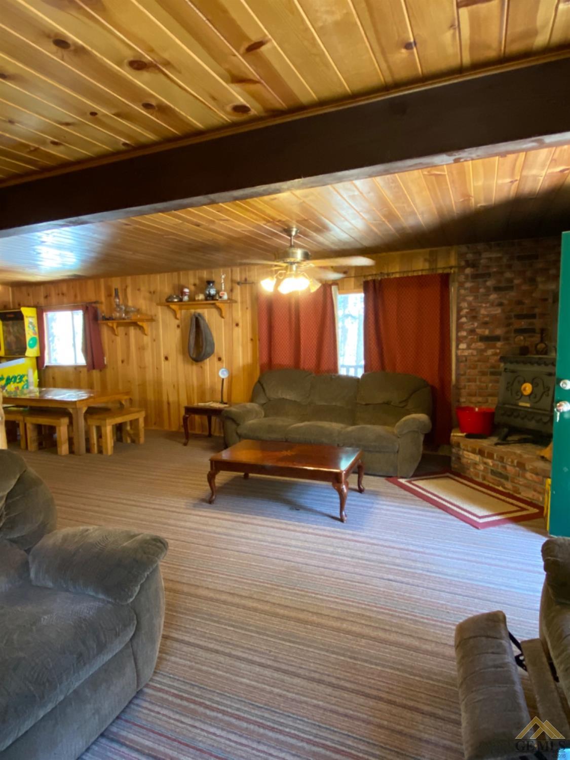 Undisclosed Address Posey, CA 93260 - Photo 2 of 20 a living room with furniture a flat screen tv and gym equipment