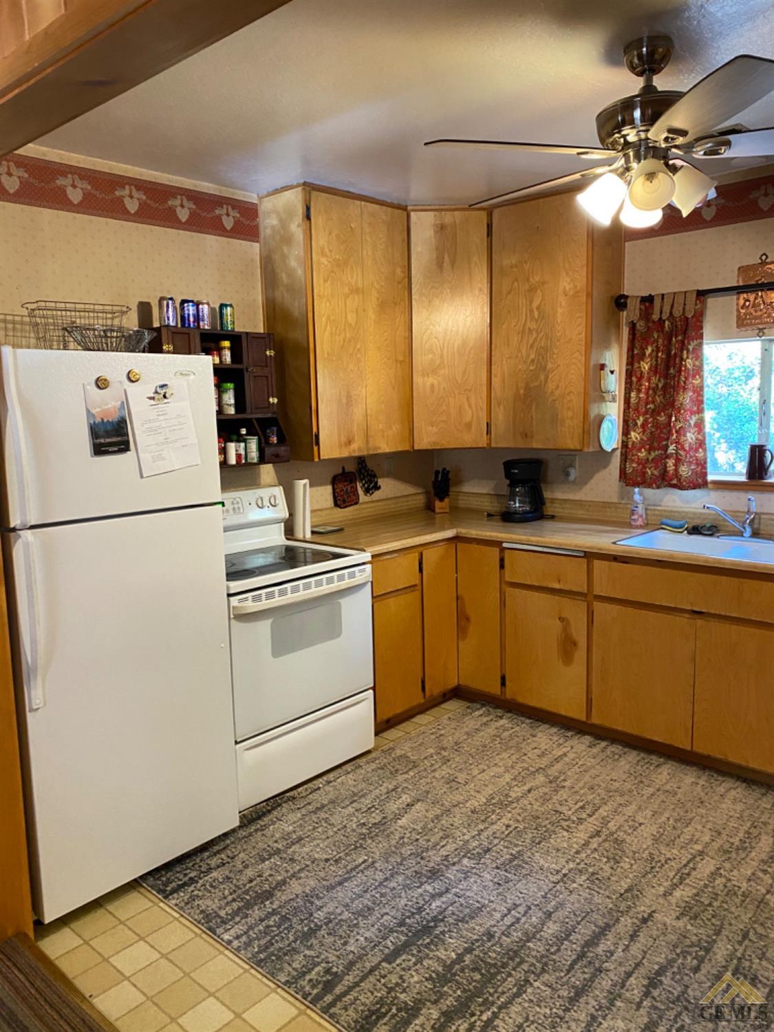 Undisclosed Address Posey, CA 93260 - Photo 6 of 20 a kitchen with a stove a sink and a refrigerator