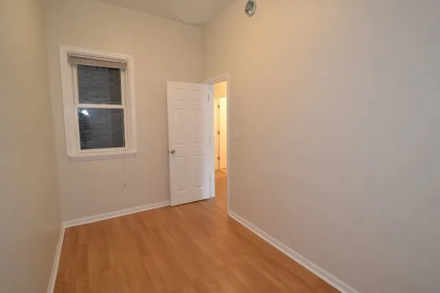 a view of a room with wooden floor and white walls