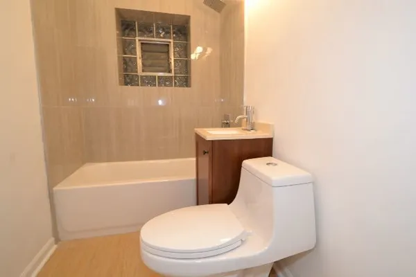 a view of a kitchen with wooden floor and a refrigerator