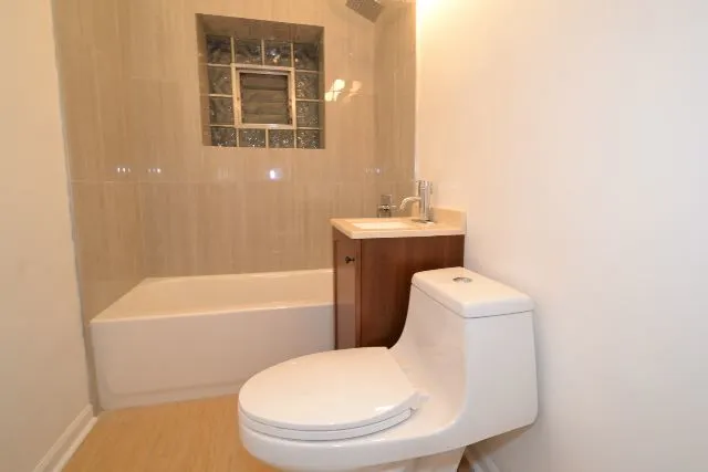 a view of a kitchen with wooden floor and a refrigerator