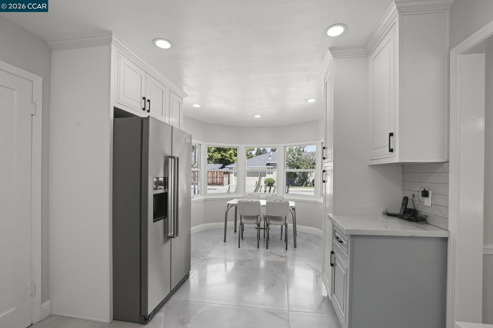 1051 San Rafael Street San Leandro, CA 94577 - Photo 12 of 26 a dining room with furniture and a kitchen view