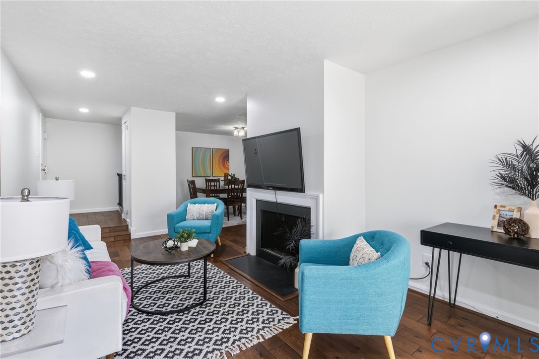 1507 Largo Road, Unit 304 Henrico, VA 23238 - Photo 1 of 1 a living room with furniture a flat screen tv and a fireplace