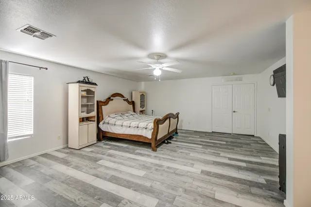 a spacious bedroom with a bed and window