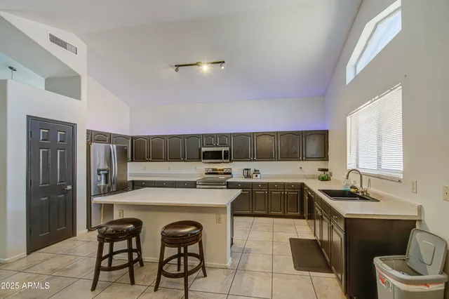 a kitchen with a sink cabinets and stainless steel appliances