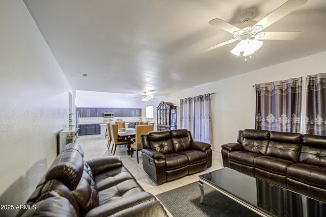 a living room with furniture ceiling fan and a rug