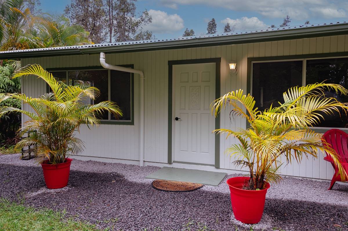 16-1404 Hopue Road Mountain View, HI 96771 - Photo 1 of 28 a potted plant sitting in front of a house