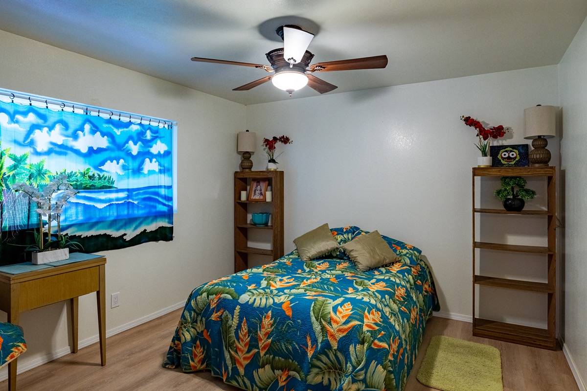 16-1404 Hopue Road Mountain View, HI 96771 - Photo 11 of 28 a bedroom with a bed and a bookshelf