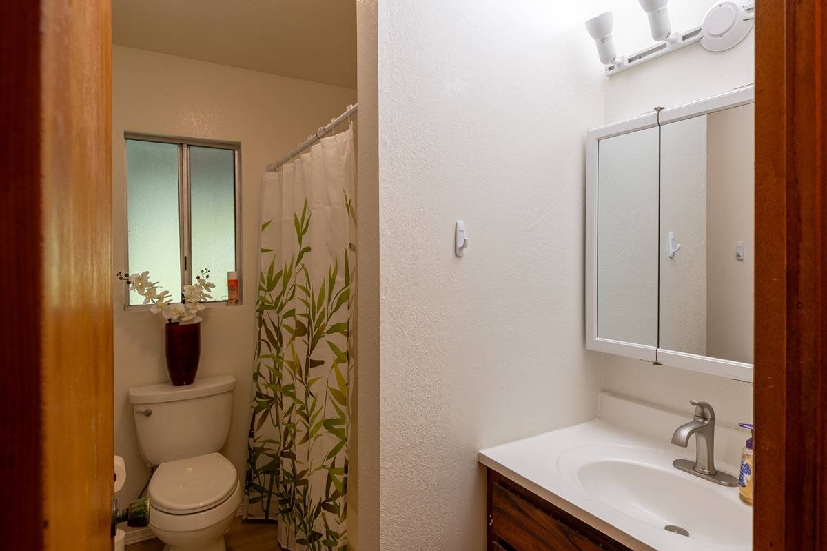 16-1404 Hopue Road Mountain View, HI 96771 - Photo 12 of 28 a bathroom with a sink toilet and shower