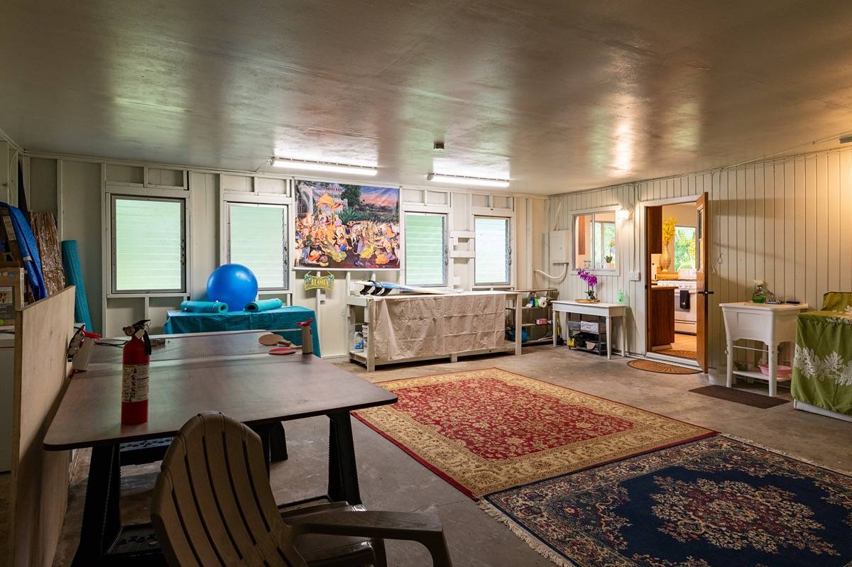 16-1404 Hopue Road Mountain View, HI 96771 - Photo 14 of 28 a living room with furniture flat screen tv and a table