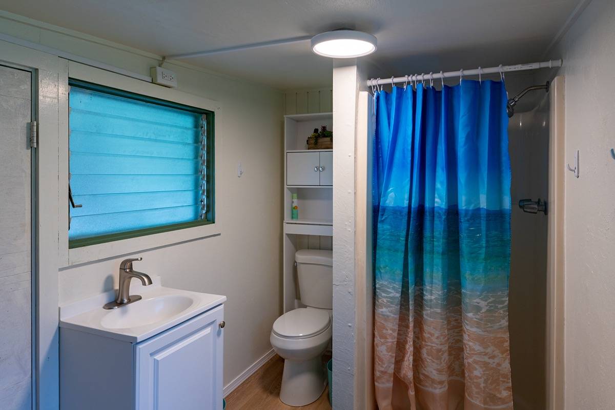 16-1404 Hopue Road Mountain View, HI 96771 - Photo 16 of 28 a bathroom with a sink a toilet and shower