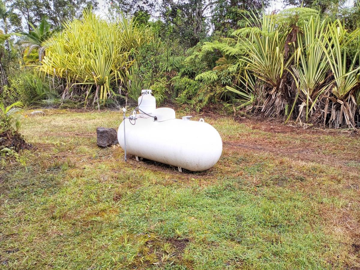 16-1404 Hopue Road Mountain View, HI 96771 - Photo 26 of 28 a backyard of a house with table and chairs