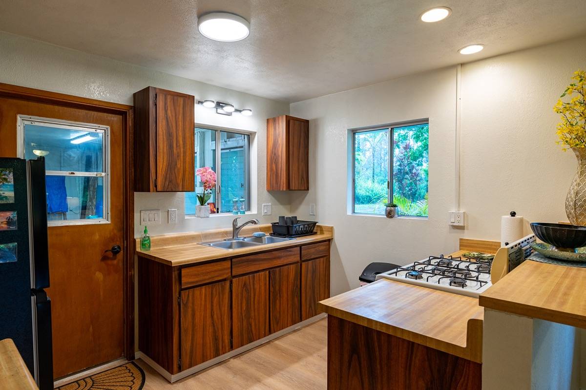 16-1404 Hopue Road Mountain View, HI 96771 - Photo 9 of 28 a kitchen with a sink stove and refrigerator