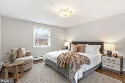 a bedroom with bed and a couch