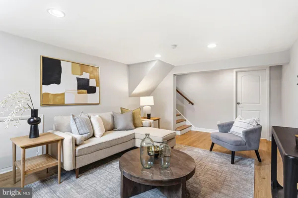a living room with furniture and wooden floor