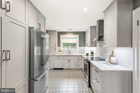 a kitchen with a sink stove and refrigerator