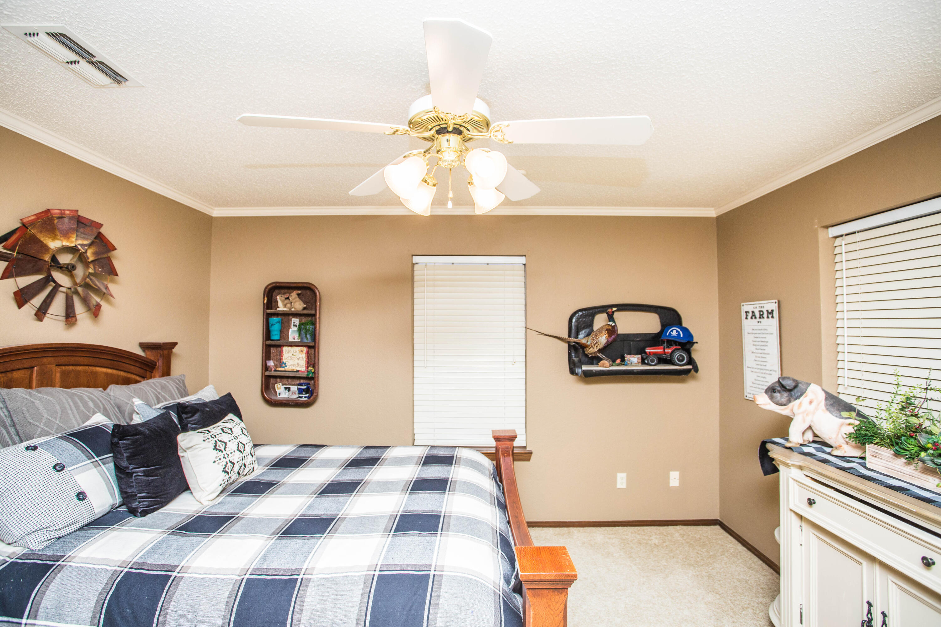 1304 Jefferson Drive Plainview, TX 79072 - Photo 33 of 50 a bedroom with a bed and a chandelier