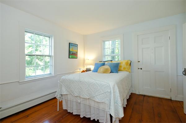 137 North Road Bedford, MA 01730 - Photo 15 of 23 a bedroom with a bed and wooden floor