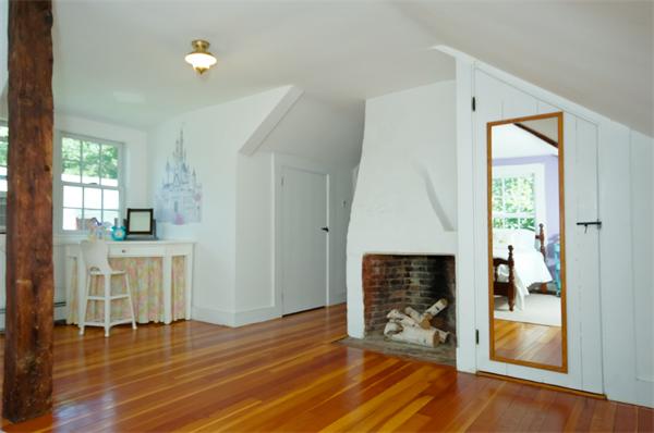 137 North Road Bedford, MA 01730 - Photo 17 of 23 a view of an empty room with wooden floor and a fireplace