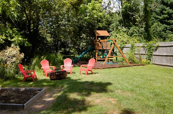 137 North Road Bedford, MA 01730 - Photo 20 of 23 a backyard of a house with table and chairs
