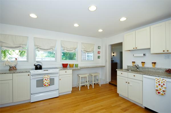 137 North Road Bedford, MA 01730 - Photo 8 of 23 a kitchen that has a lot of cabinets in it and wooden floors