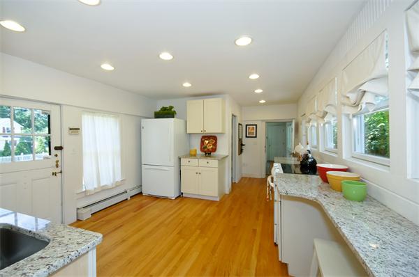 137 North Road Bedford, MA 01730 - Photo 9 of 23 a large white kitchen with a large window
