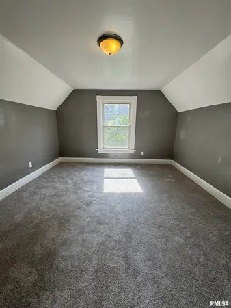 an empty room with windows and natural light