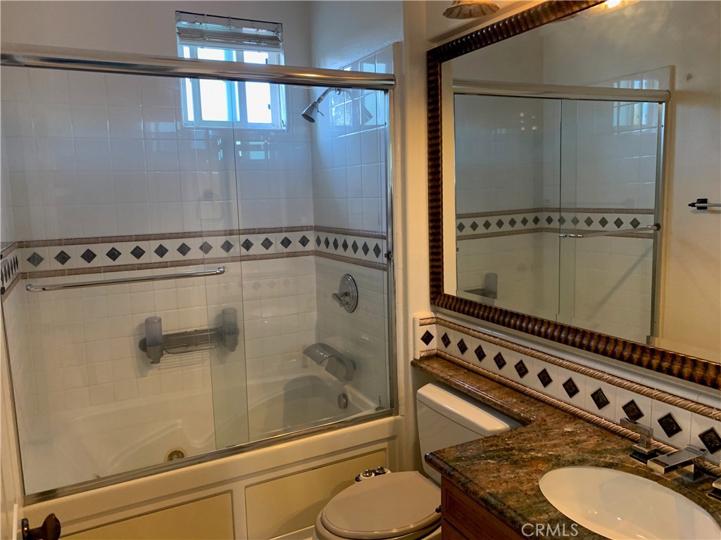 44 Whitford Irvine, CA 92602 - Photo 19 of 20 a bathroom with a granite countertop sink mirror and vanity