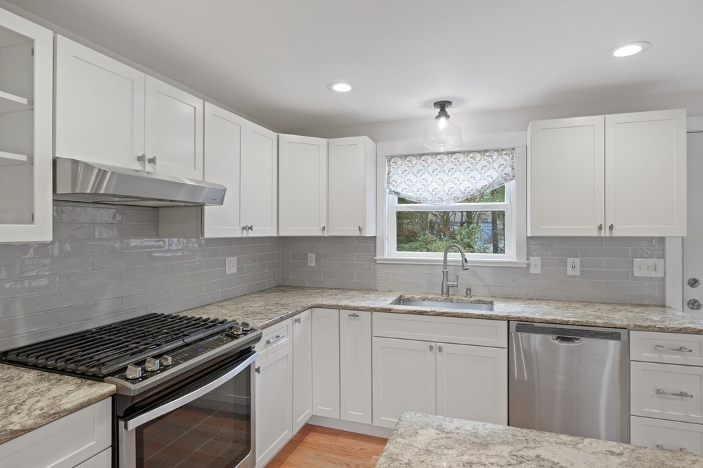 29 Stuart Road Rochester, MA 02770 - Photo 11 of 41 a kitchen with granite countertop a sink stove and cabinets