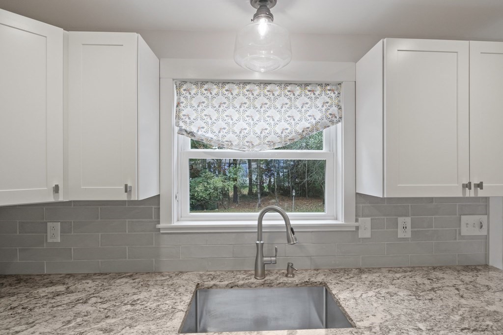 29 Stuart Road Rochester, MA 02770 - Photo 13 of 41 a kitchen with granite countertop a sink and a window
