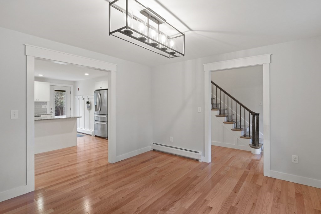 29 Stuart Road Rochester, MA 02770 - Photo 21 of 41 a view of a hallway with wooden floor and a chandelier