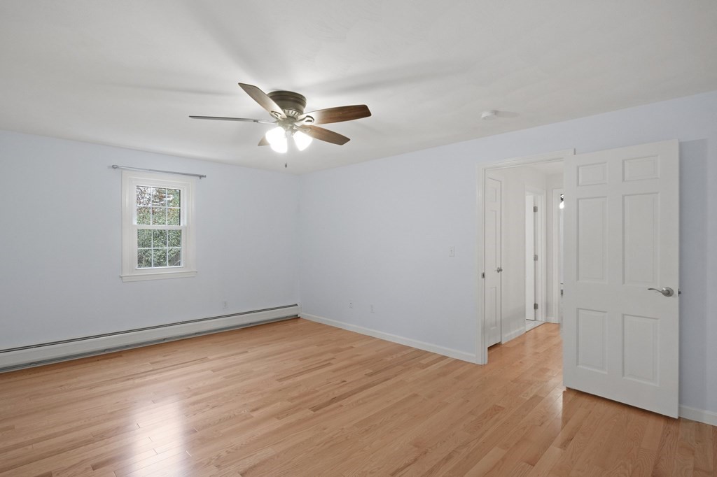 29 Stuart Road Rochester, MA 02770 - Photo 35 of 41 wooden floor in an empty room with a window