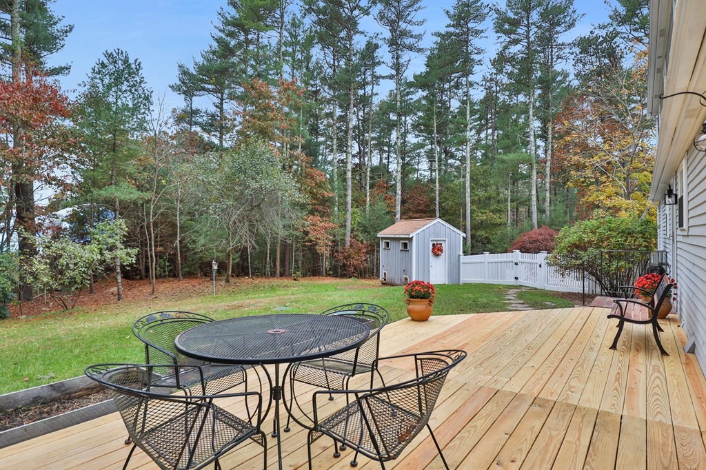29 Stuart Road Rochester, MA 02770 - Photo 36 of 41 a view of a backyard with table and chairs potted plants and large tree