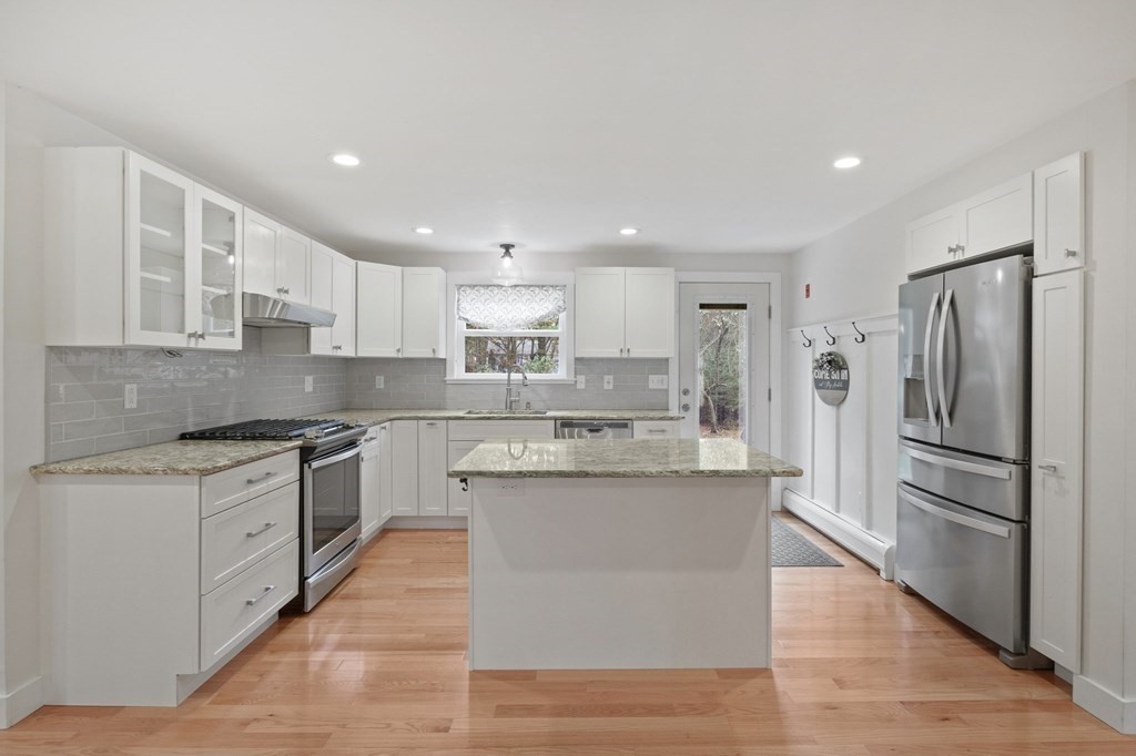 29 Stuart Road Rochester, MA 02770 - Photo 8 of 41 a kitchen with stainless steel appliances granite countertop a refrigerator a stove and a sink