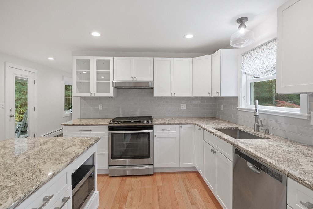 29 Stuart Road Rochester, MA 02770 - Photo 9 of 41 a kitchen with stainless steel appliances granite countertop a sink stove and cabinets