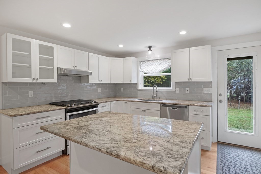 29 Stuart Road Rochester, MA 02770 - Photo 10 of 41 a kitchen with kitchen island granite countertop a stove sink and cabinets