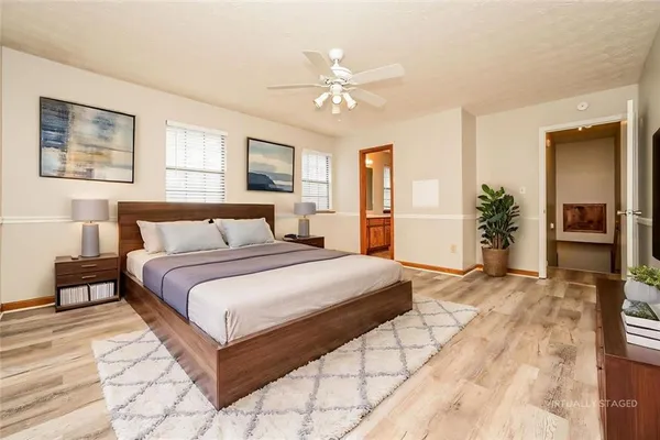 a bedroom with a large bed and a chandelier
