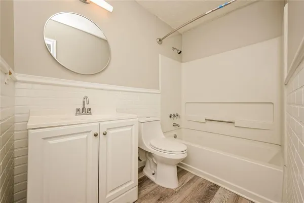 a bathroom with a sink a toilet and bathtub