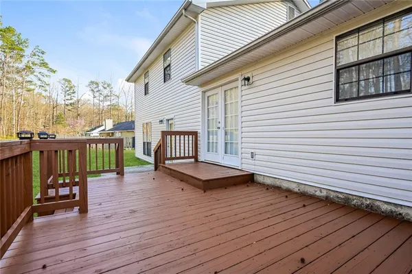 a view of a roof deck with wooden floor and fence