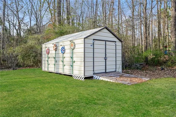 a view of house with backyard and garden