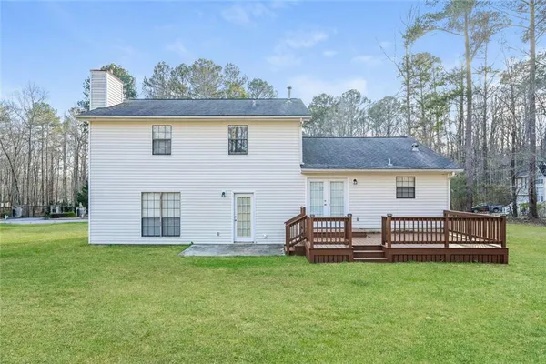 a view of a house with backyard and a chair