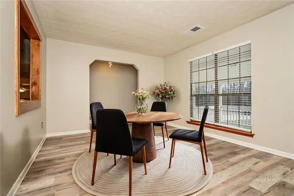 a view of a dining room with furniture window and wooden floor