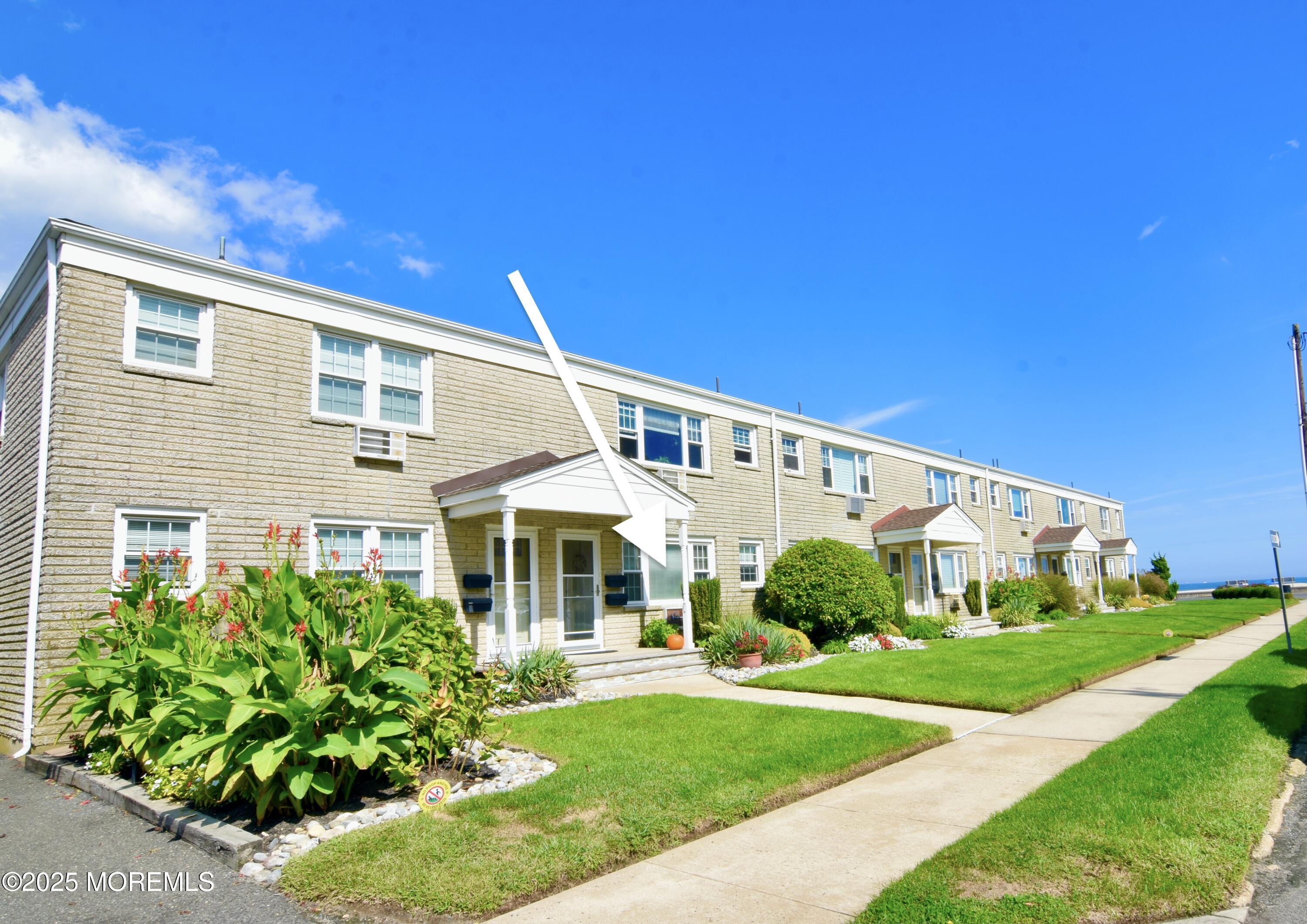 1304 Ocean Avenue, Unit 2A Belmar, NJ 07719 - Photo 2 of 25 a front view of a house with a yard