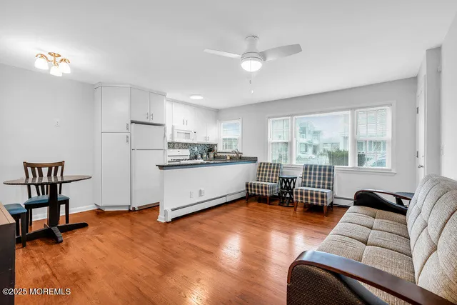 a living room with furniture and a table with wooden floor