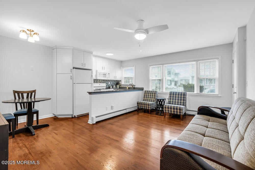 1304 Ocean Avenue, Unit 2A Belmar, NJ 07719 - Photo 3 of 25 a living room with furniture and a table with wooden floor