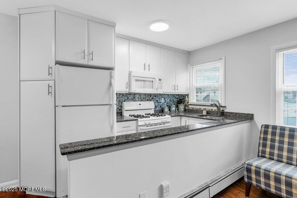 1304 Ocean Avenue, Unit 2A Belmar, NJ 07719 - Photo 9 of 25 a kitchen with stainless steel appliances granite countertop a refrigerator sink and white cabinets