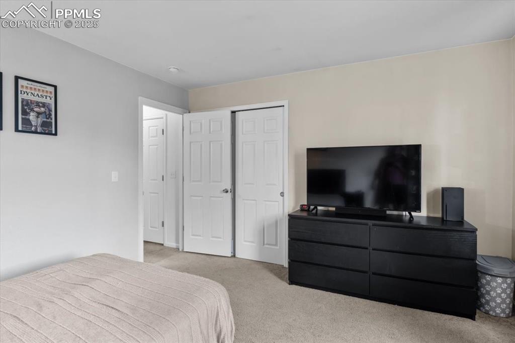 1649 Reilly Grove Colorado Springs, CO 80951 - Photo 15 of 20 a bedroom with a bed and a flat screen tv