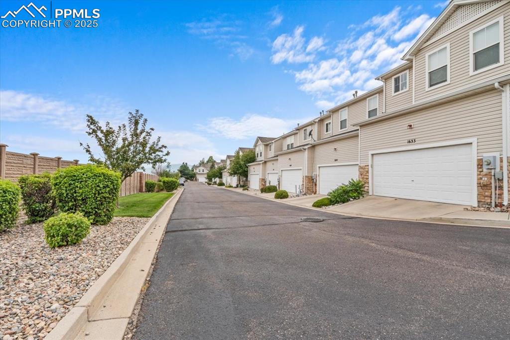 1649 Reilly Grove Colorado Springs, CO 80951 - Photo 20 of 20 a house with a yard and a car park in front of it